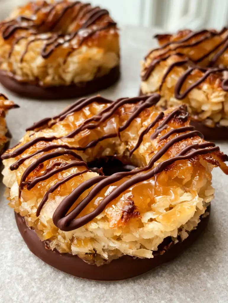 No-Bake Samoa Cookies: The Ultimate Easy Copycat Recipe 1 Close up of No-Bake Samoa Cookies featuring precise dark chocolate zigzag stripes and amber caramel highlights.